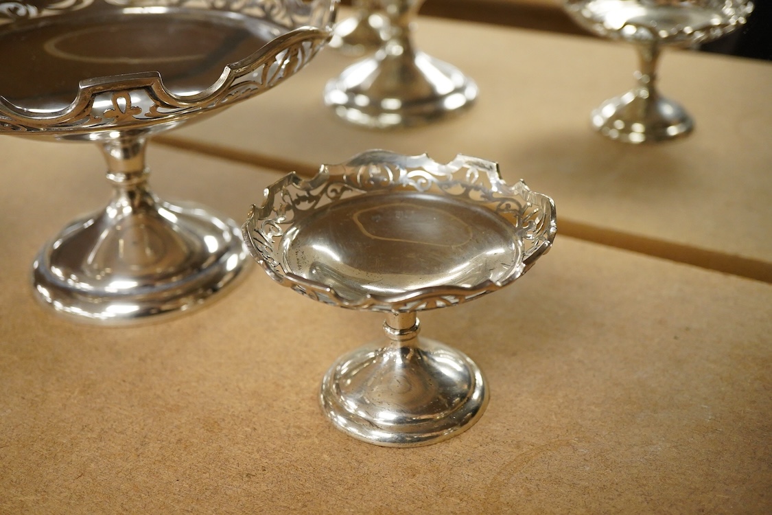 A suite of three George V graduated comports, by Stuart Dawson & Co Ltd, London, 1911, with pierced borders, comprising a large comport height 11.9cm and pair of smaller comports, height 7.2cm, 20oz.